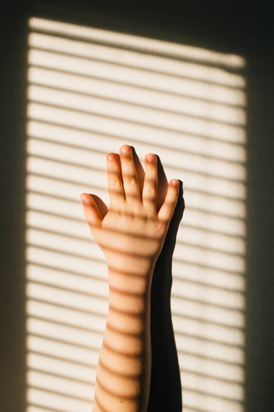 Photo of a childs hand in sunlight