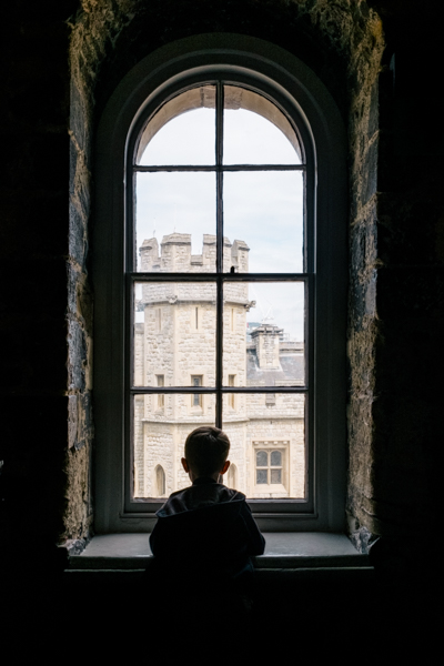 Photo of a boy standing at a window
