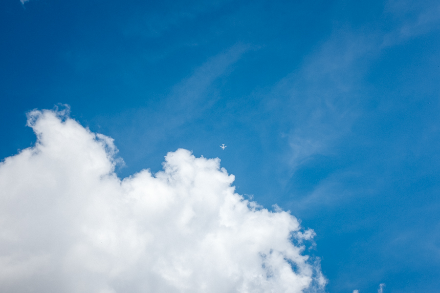 Photo of a plane flying into a cloud